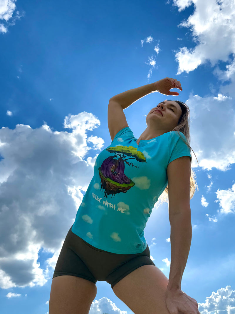 Dr. Mondragon in a blue t-shirt with a graphic design against a blue sky with clouds