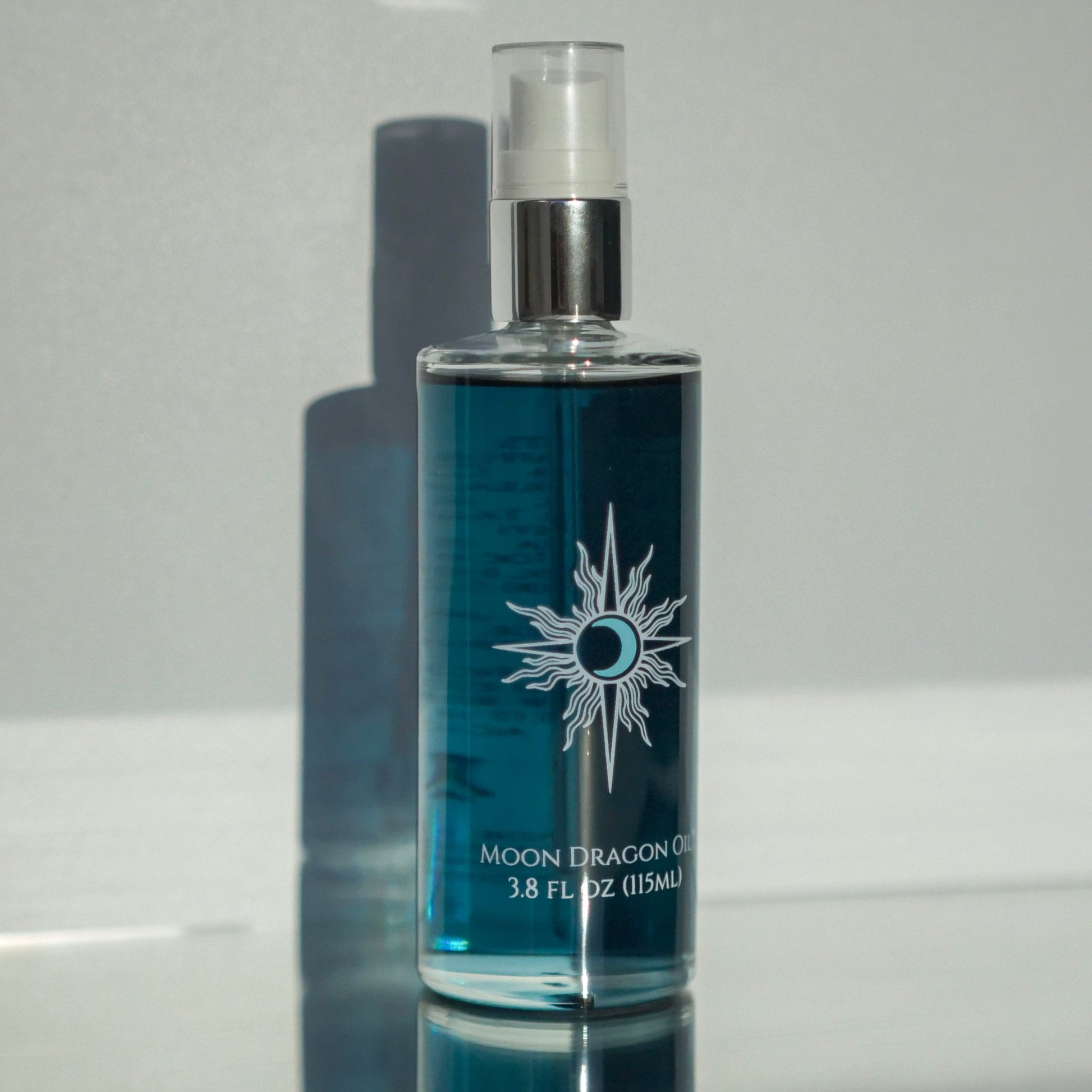 Blue bottle with silver cap on a reflective surface