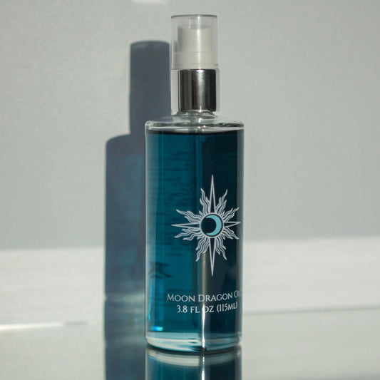 Blue bottle with silver cap on a reflective surface