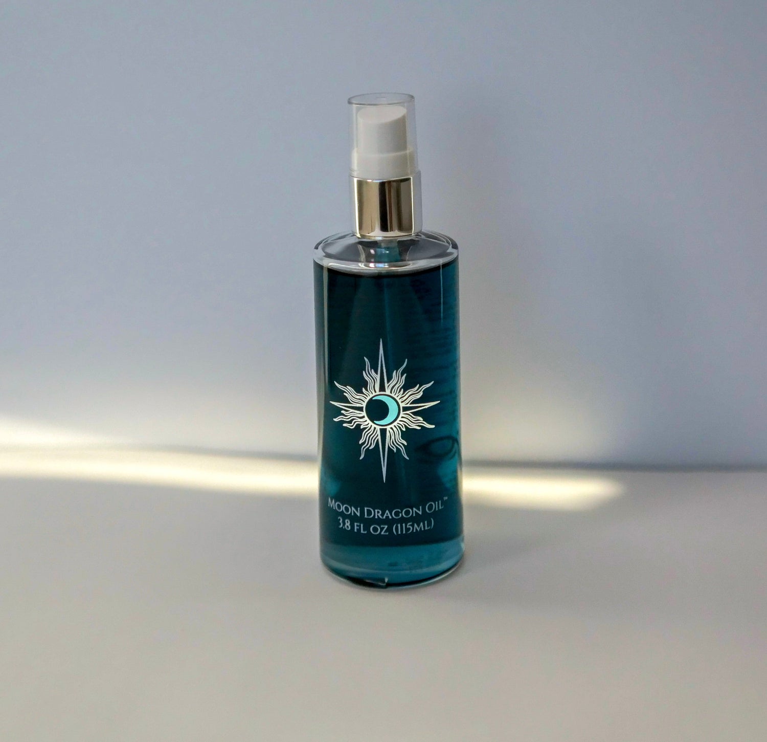 Blue bottle with a silver cap on a gray background